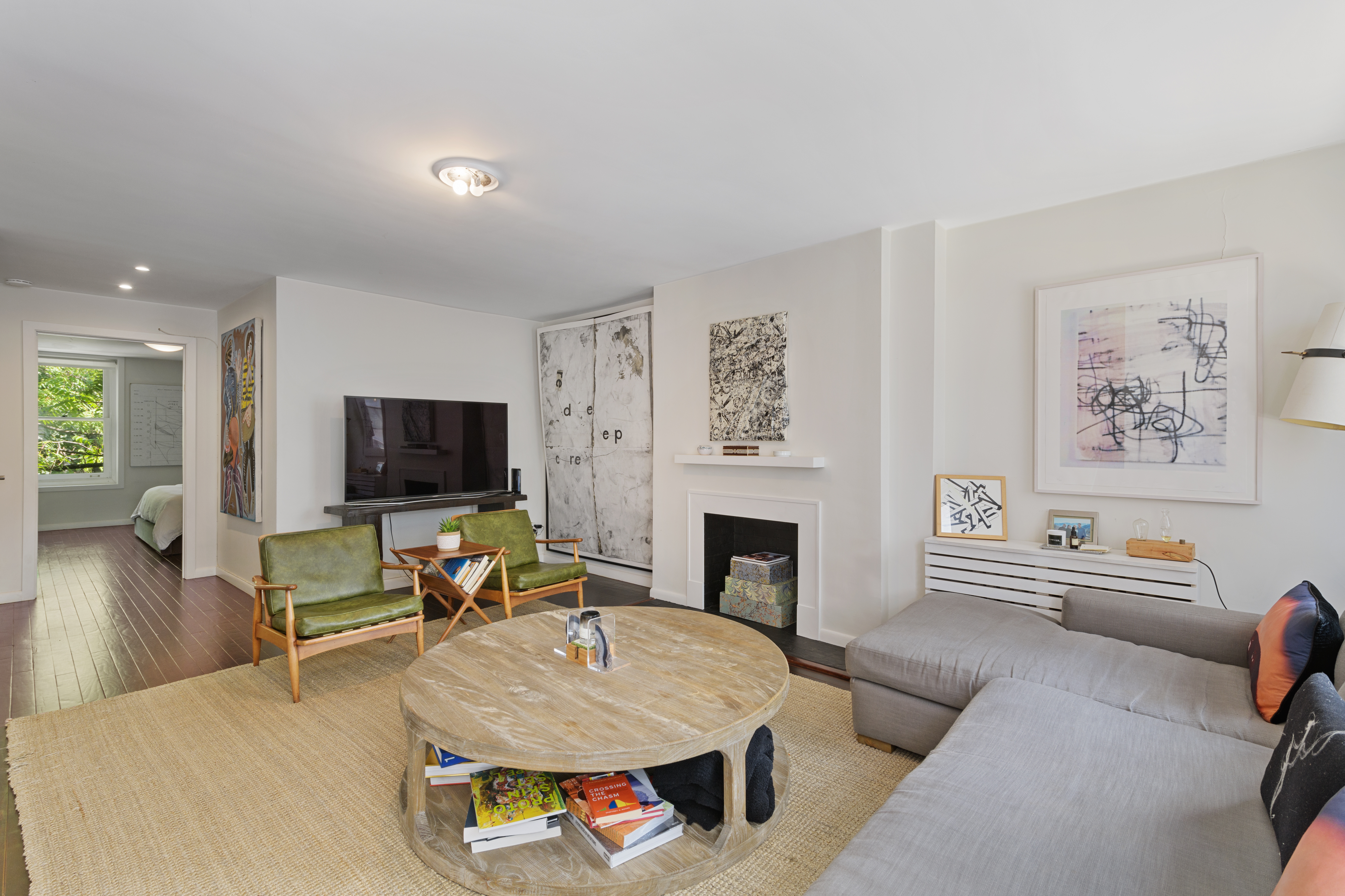 24 Greenwich Avenue, Unit 2 Manhattan, NY 10011 - Photo 2 of 6 a living room with furniture and a flat screen tv