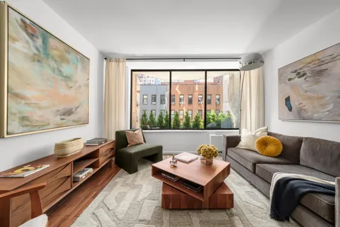 a living room with furniture and a window with outer view