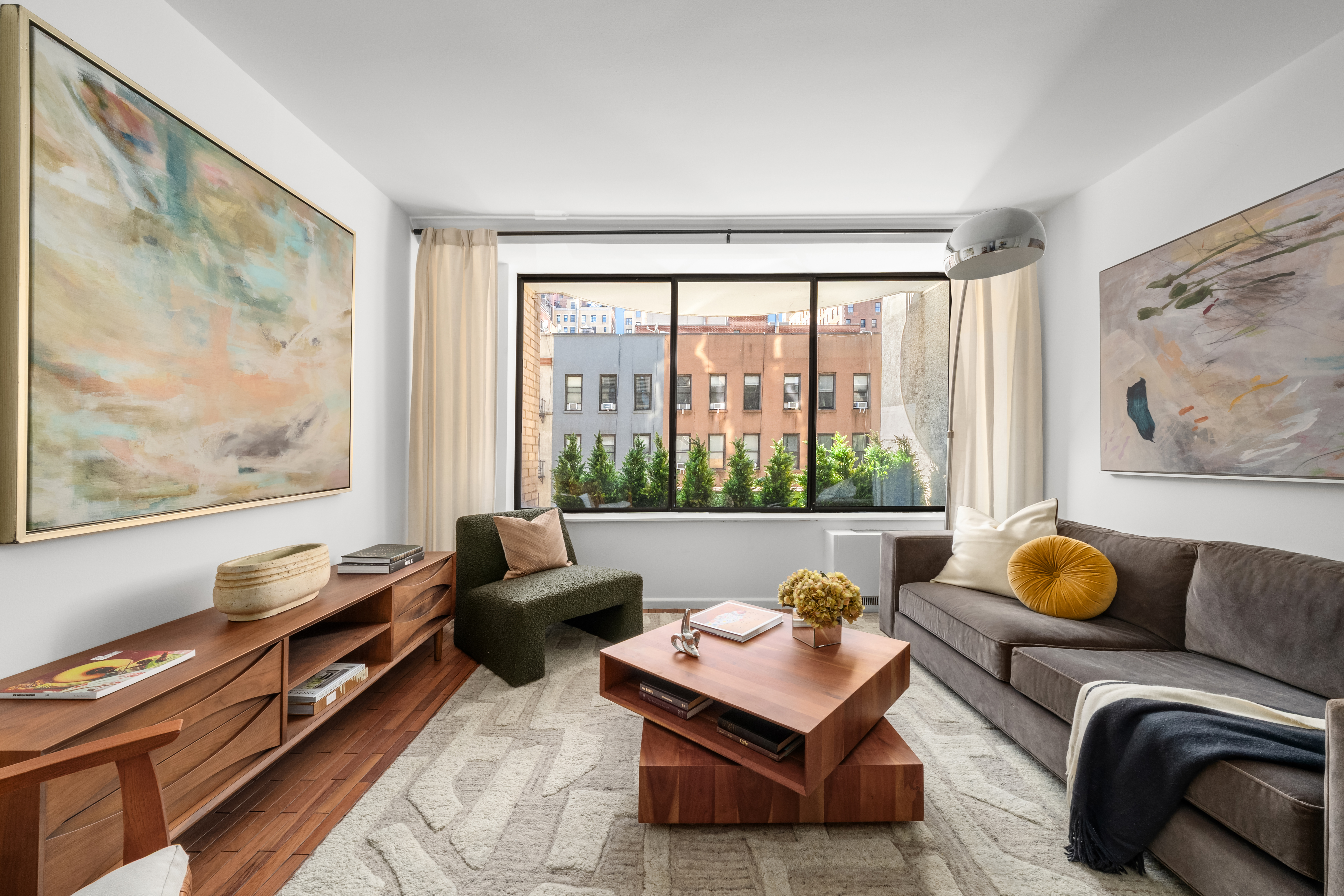 150 East 85th Street, Unit 3F Manhattan, NY 10028 - Photo 3 of 15 a living room with furniture and a window with outer view