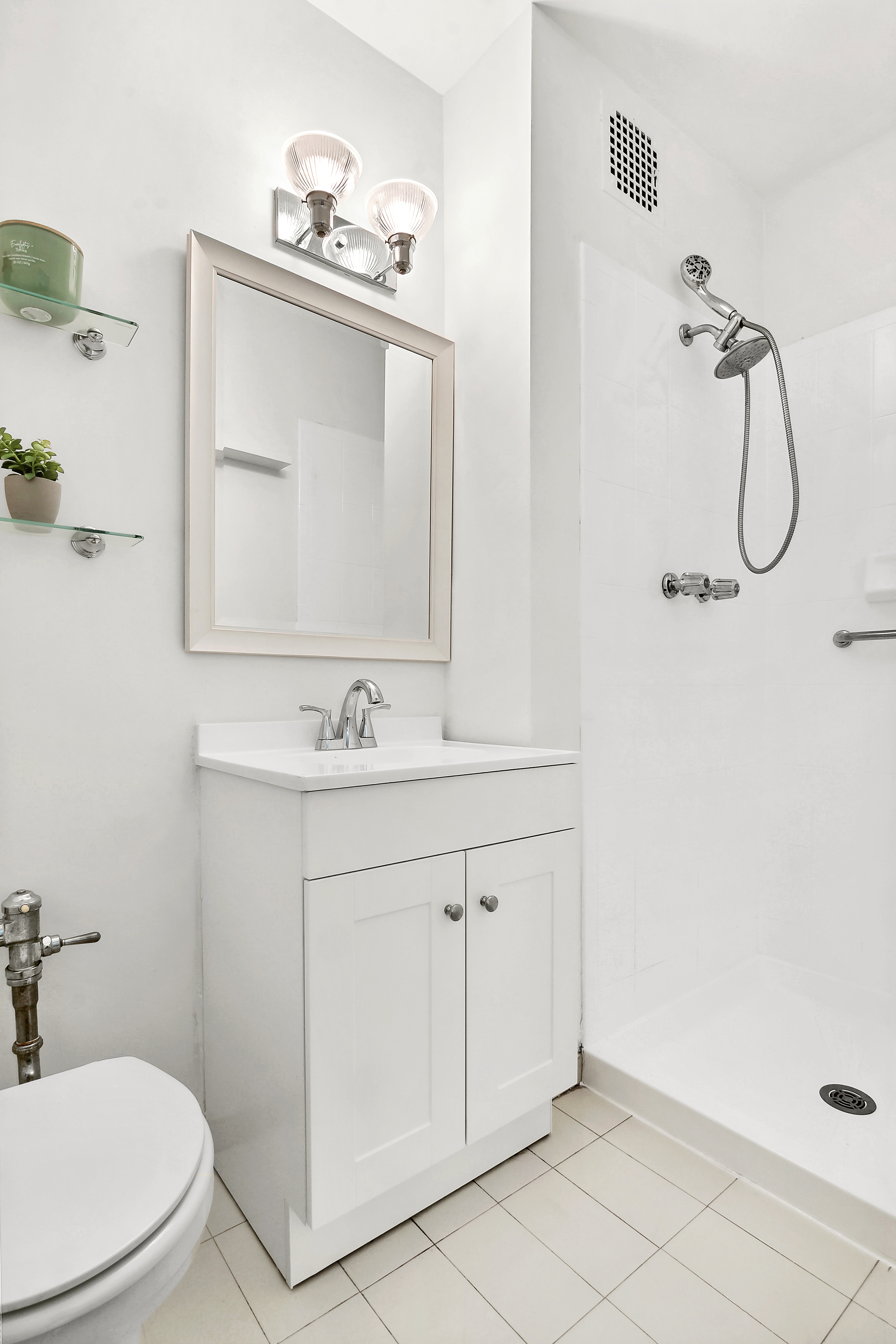 9201 Shore Road, Unit B301 Brooklyn, NY 11209 - Photo 8 of 12 a bathroom with a sink a toilet and shower