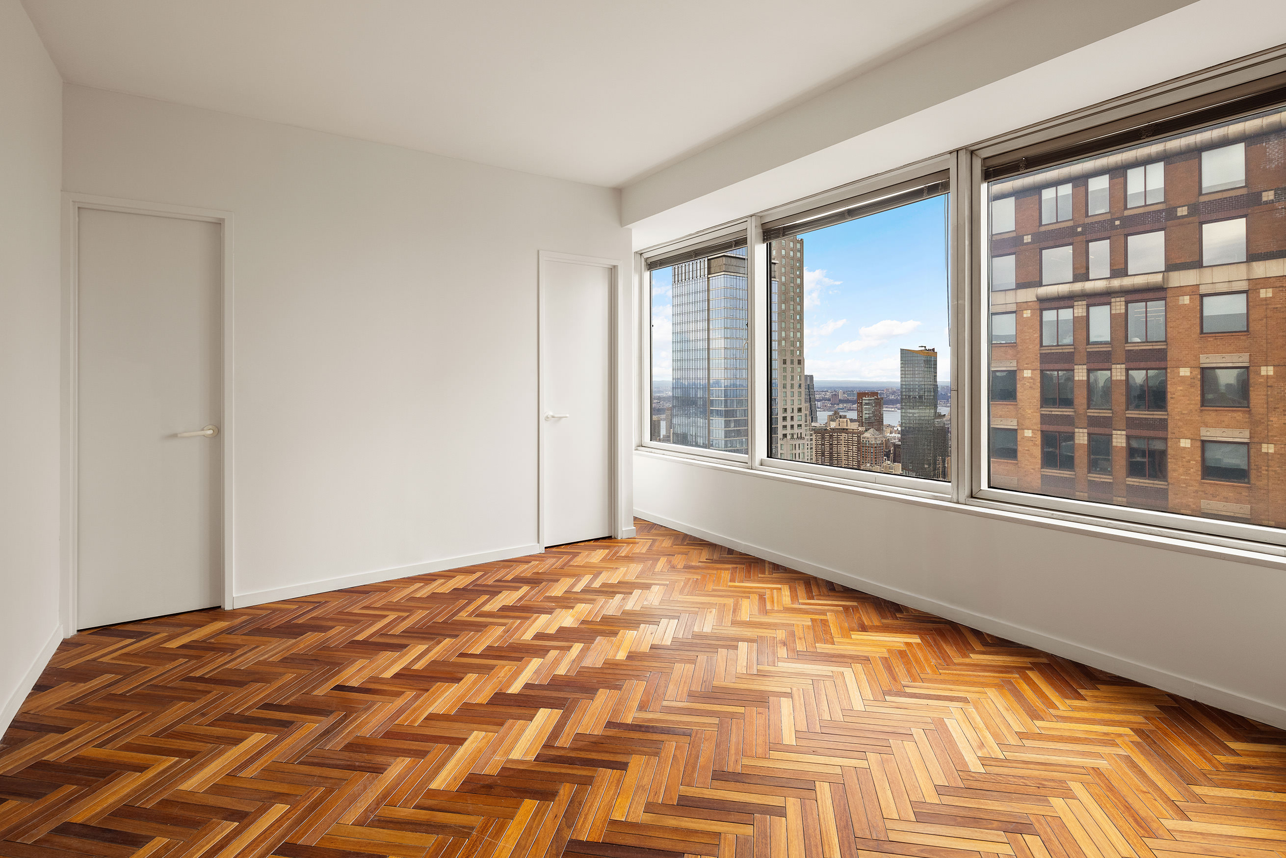 150 West 56th Street, Unit 6204 Manhattan, NY 10019 - Photo 10 of 15 a view of an empty room with a window