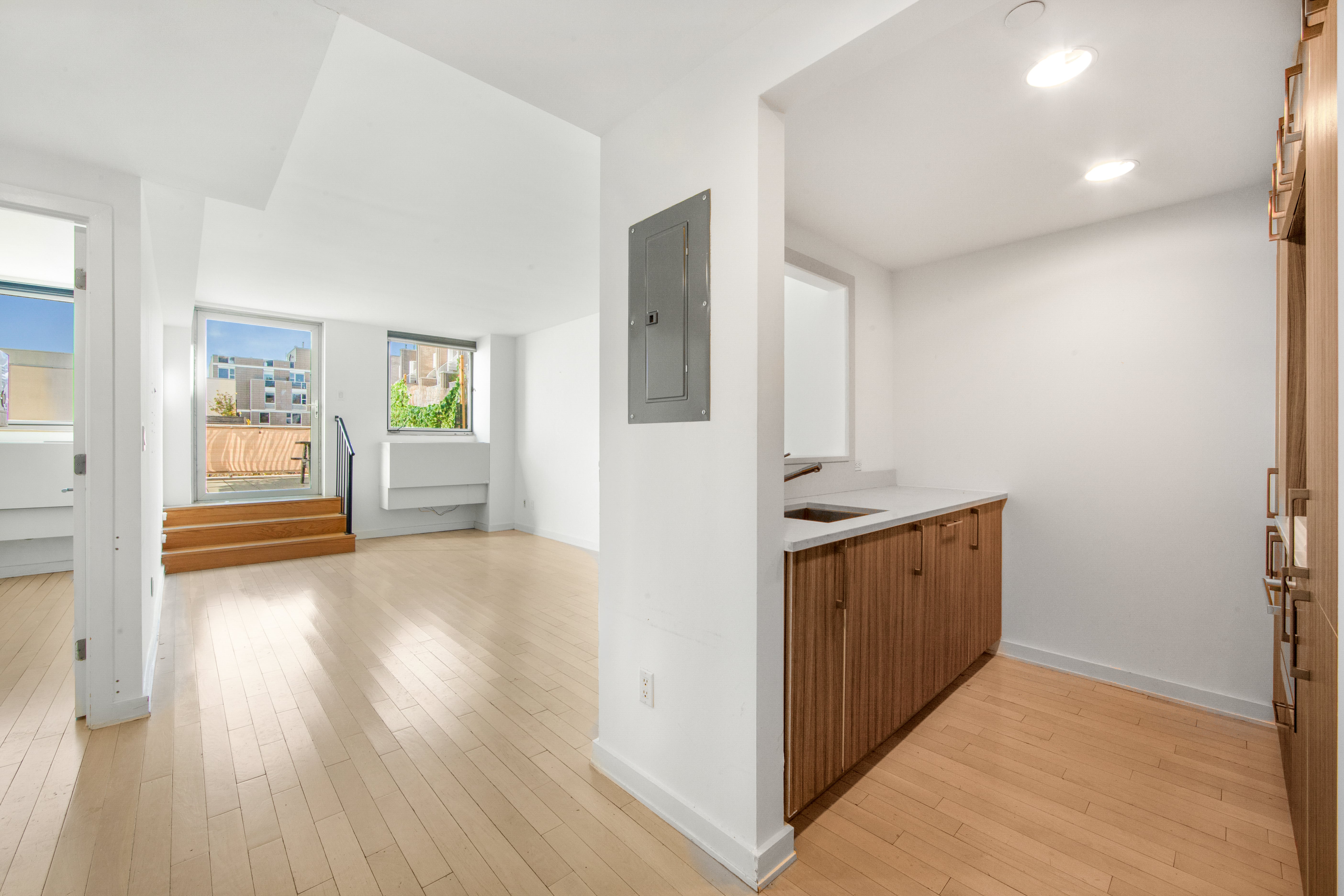 250 Bedford Avenue, Unit 129203 Brooklyn, NY 11249 - Photo 3 of 8 a view of a kitchen with wooden floor and a sink