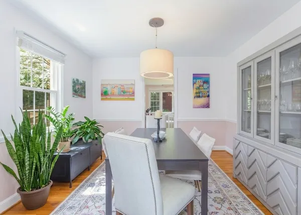 a dining room with furniture and a potted plant