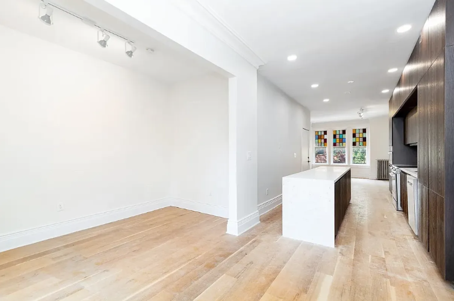 a view of kitchen with furniture and wooden floor