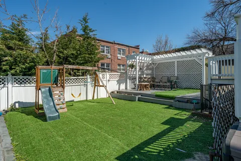 a view of a house with a yard and a slide