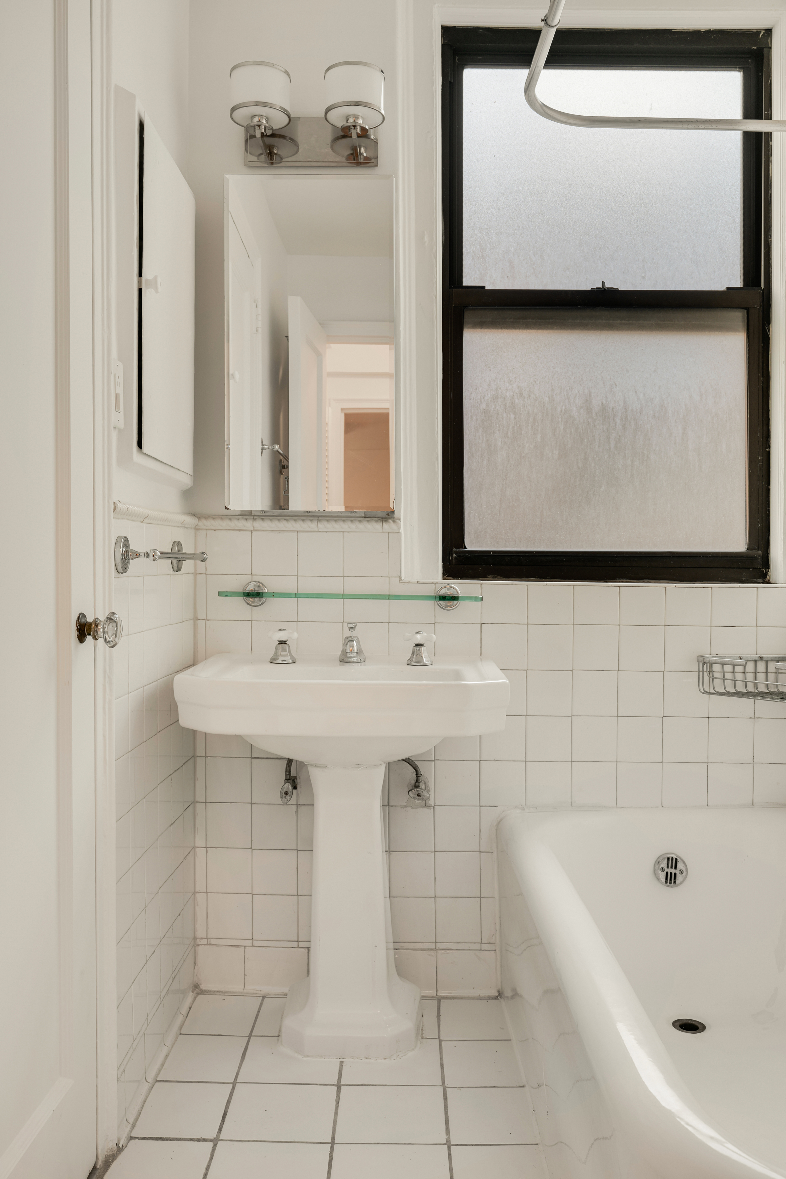 74 West 68th Street, Unit 5A Manhattan, NY 10023 - Photo 11 of 25 a bathroom with a sink a toilet and mirror