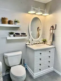 a bathroom with a toilet a sink and a mirror