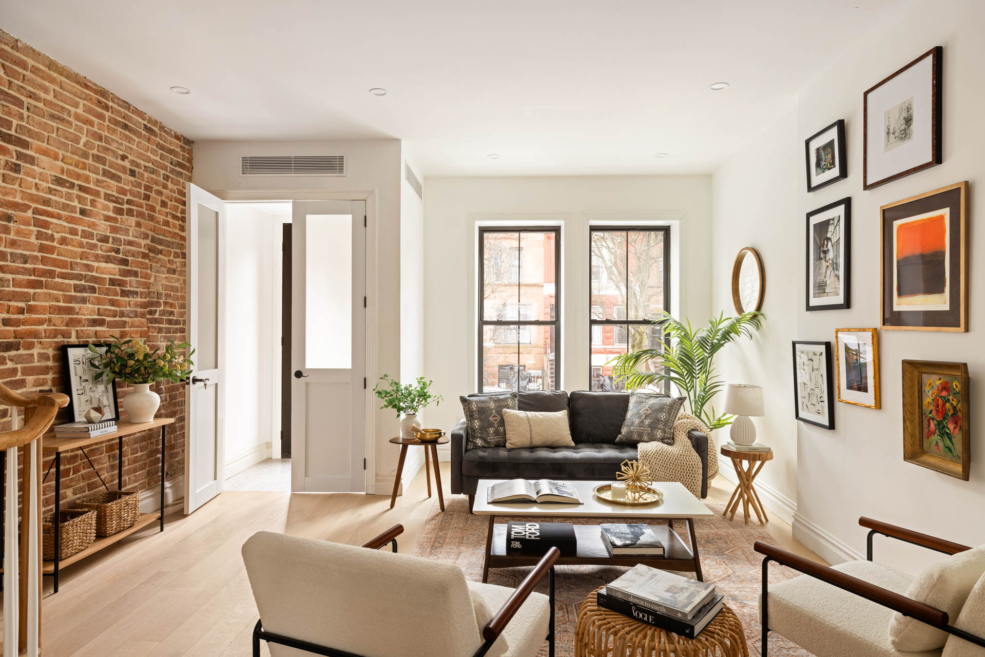 a living room with furniture and large windows