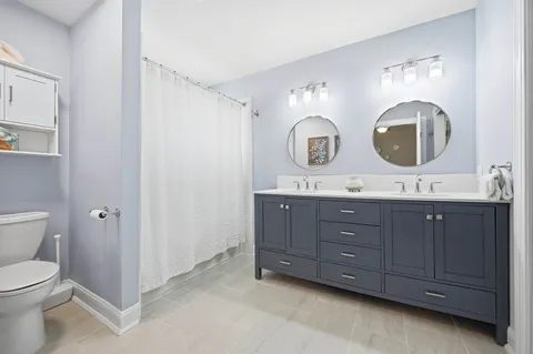 a bathroom with a double vanity sink and a mirror