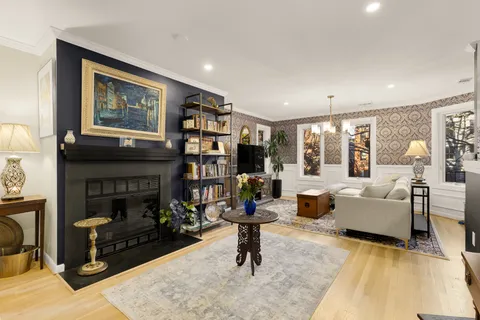 a living room with furniture large window and fireplace