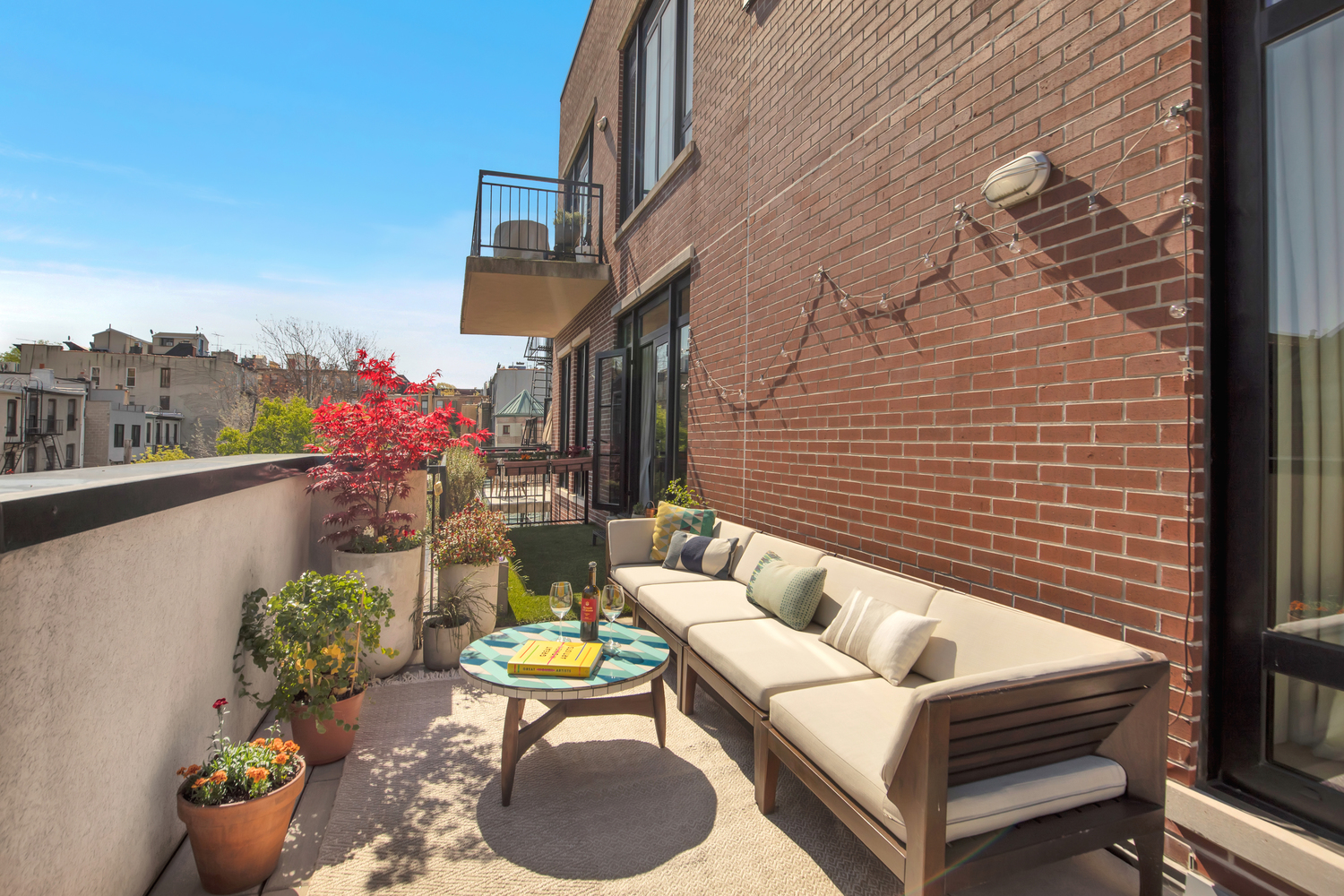 309 2nd Street, Unit 3E Brooklyn, NY 11215 - Photo 3 of 11 a view of a patio with couches table and chairs and potted plants