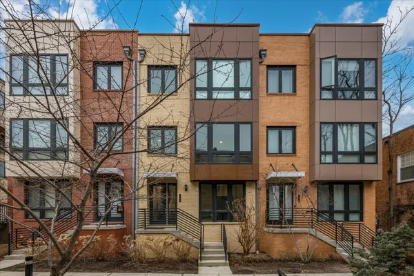 a front view of a residential apartment building with a yard