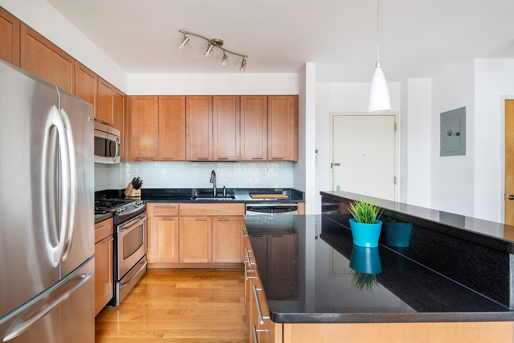 14 Hope Street, Unit 4D Brooklyn, NY 11211 - Photo 3 of 7 a kitchen with stainless steel appliances granite countertop a refrigerator a stove and a sink
