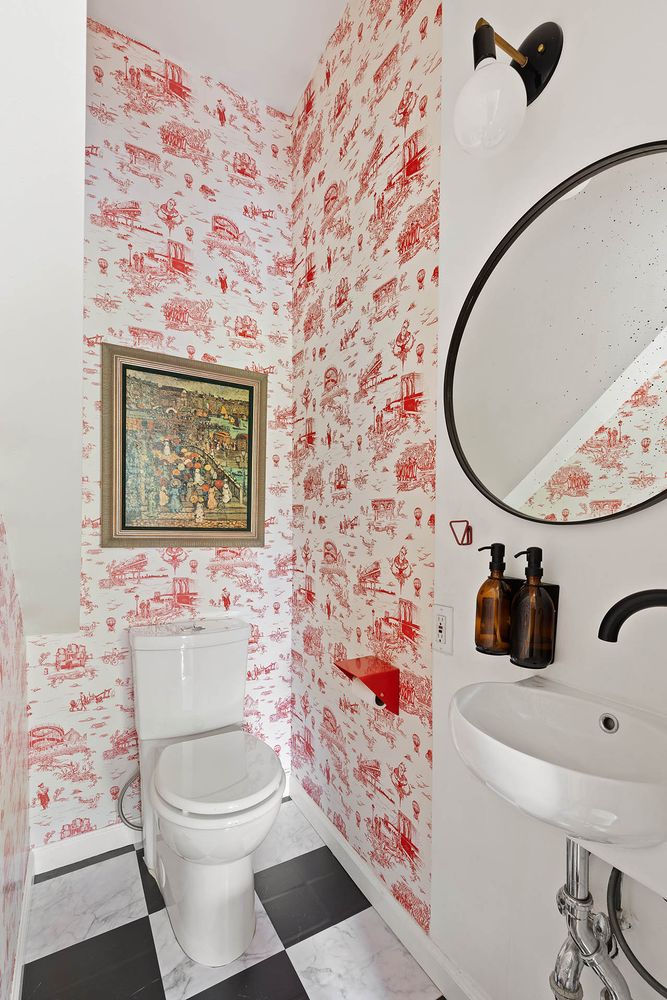 a bathroom with a toilet sink and mirror