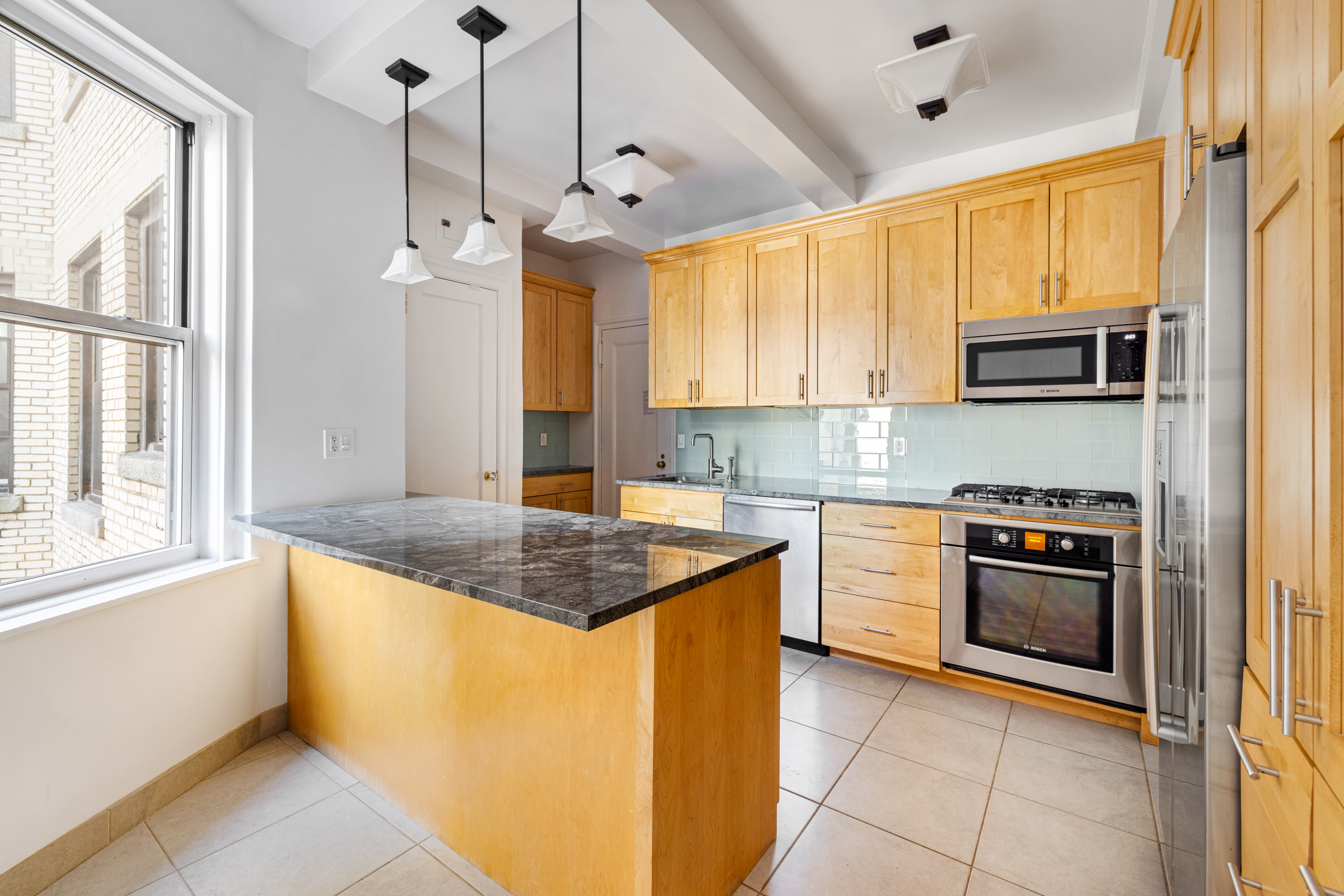 240 West 98th Street, Unit 7D Manhattan, NY 10025 - Photo 6 of 14 a kitchen with stainless steel appliances granite countertop a stove a sink and a refrigerator