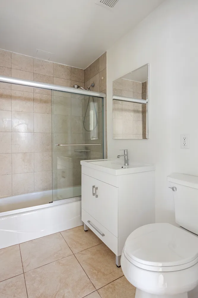 a bathroom with a toilet sink and shower