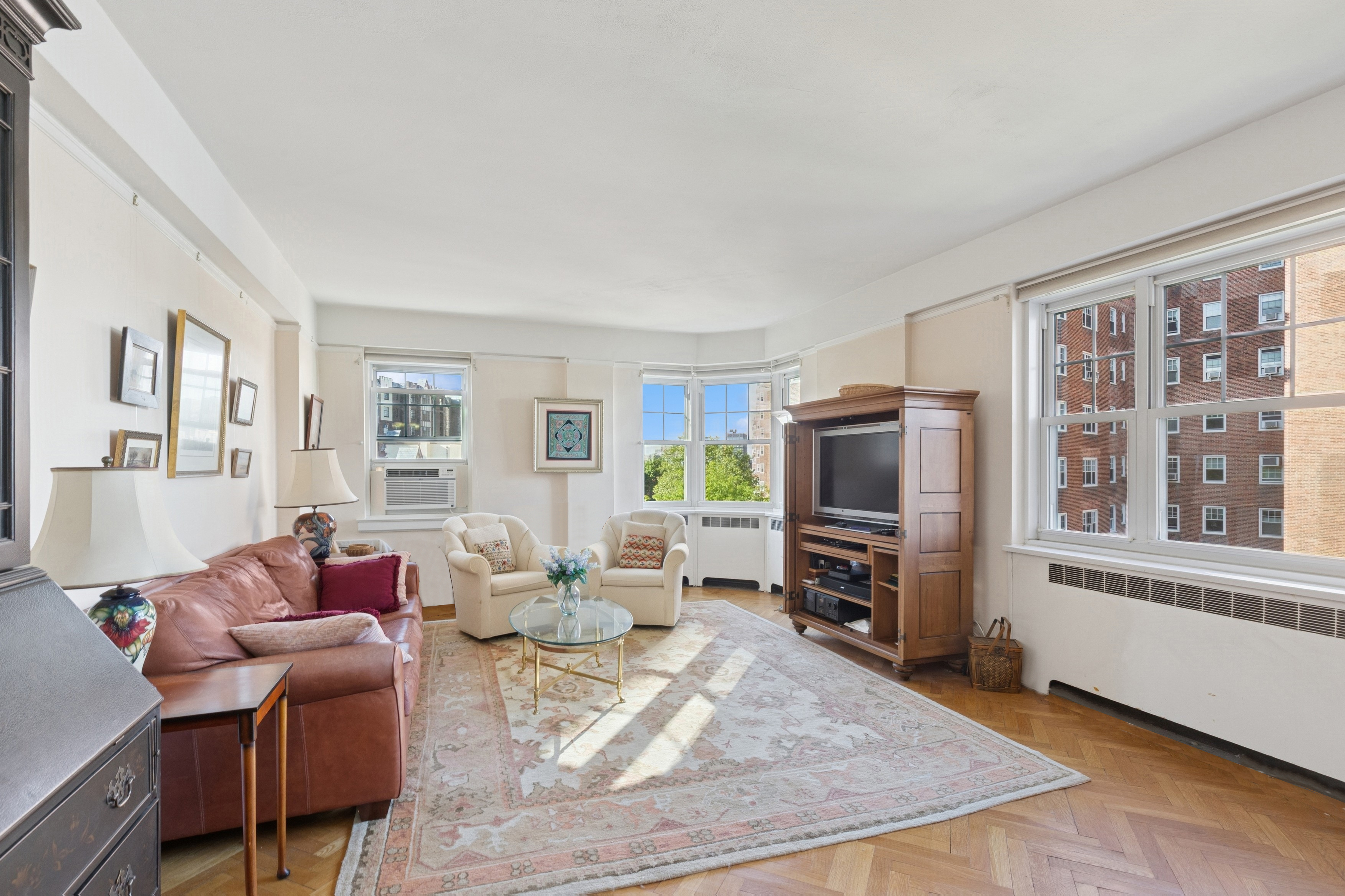 a living room with furniture windows and a flat screen tv