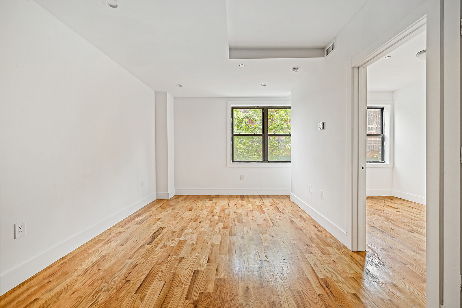 422 East 31st Street Brooklyn, NY 11226 - Photo 4 of 16 wooden floor in an empty room with a window