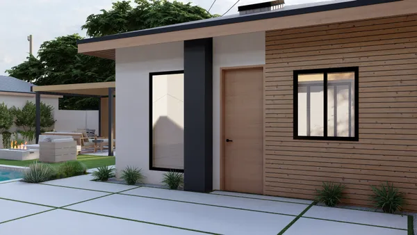 a view of a brick house with potted plants