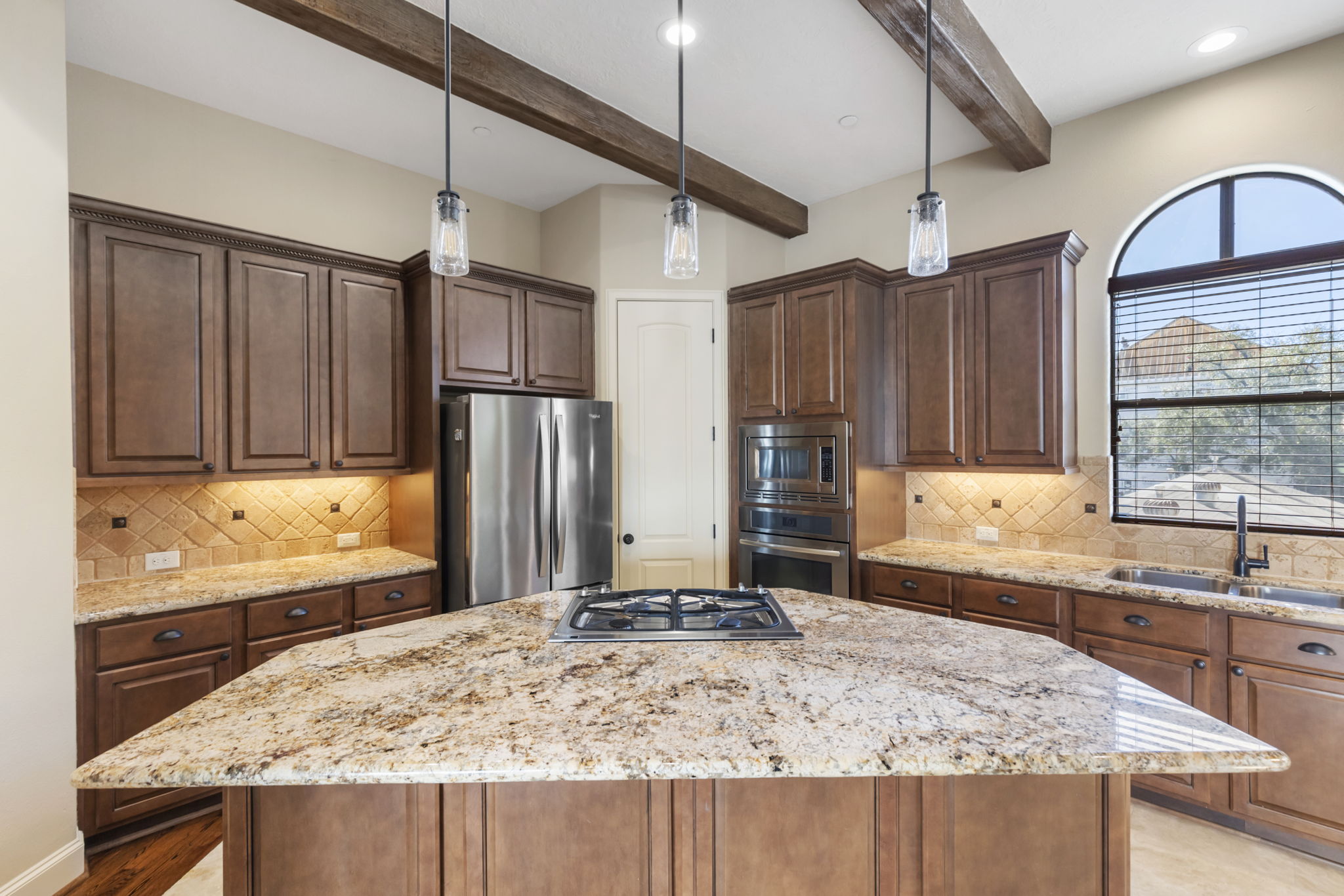 5407 Feagan Street Houston, TX 77007 - Photo 18 of 43 a kitchen with kitchen island granite countertop a sink and wooden cabinets