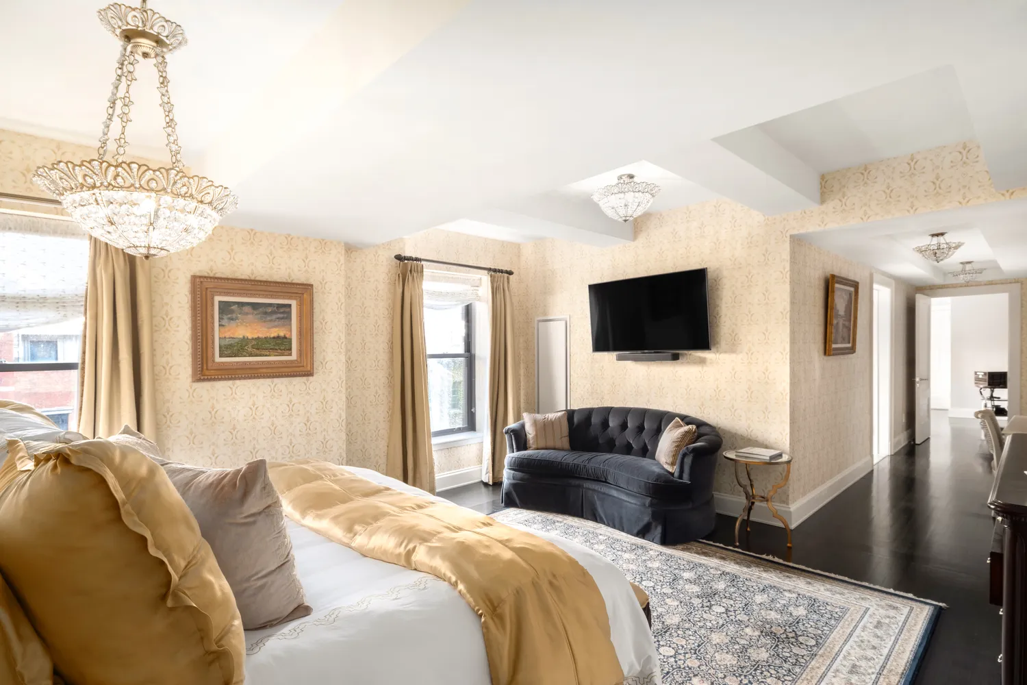 a bedroom with a bed flat screen tv and a window