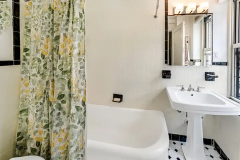 a bathroom with a sink a mirror and a bathtub