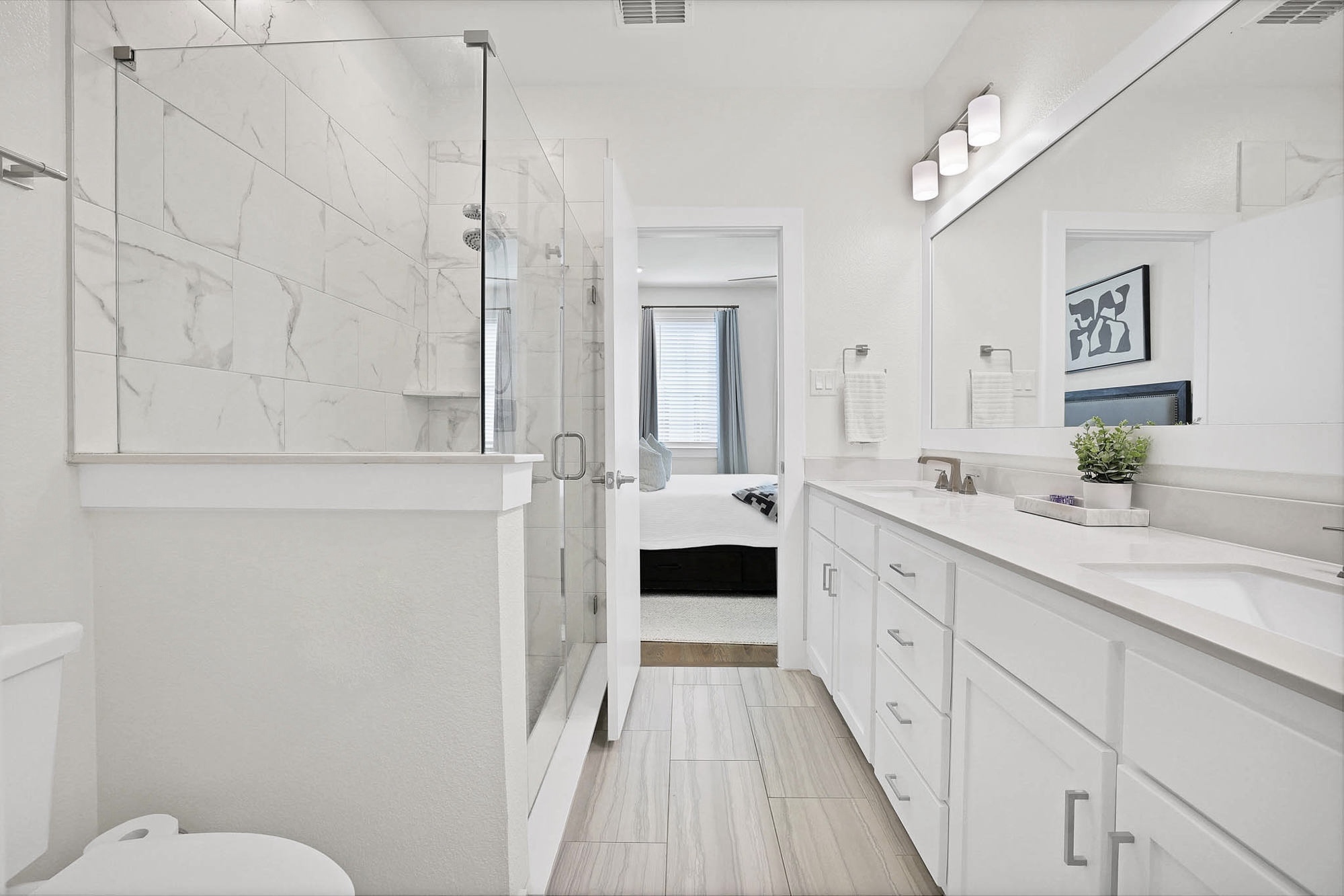 3920 Riesling Ridge Dallas, TX 75204 - Photo 16 of 26 a en suite bathroom with a double vanity sink and a mirror