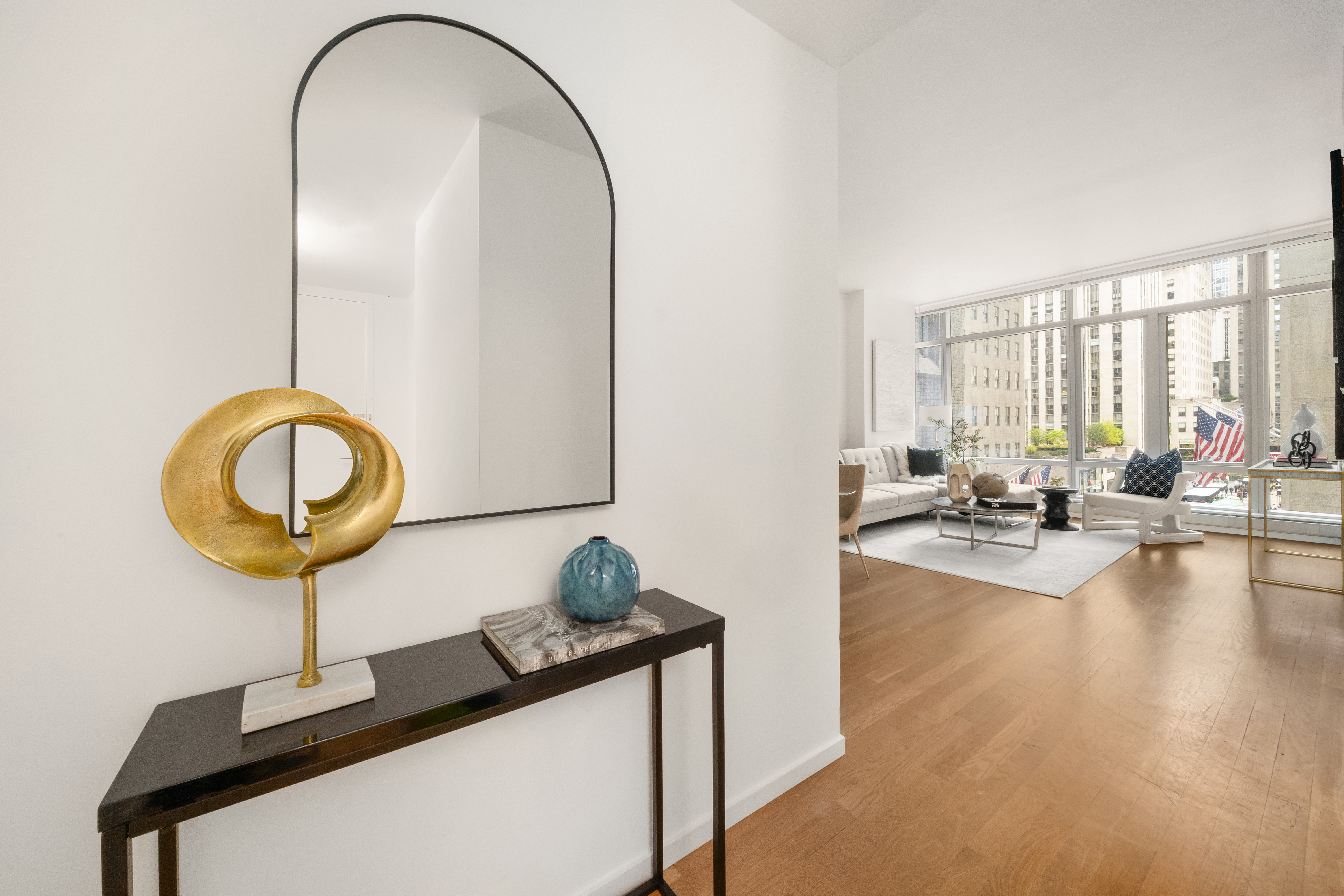 18 West 48th Street, Unit 4F Manhattan, NY 10036 - Photo 4 of 20 a view of a living room and a chandelier
