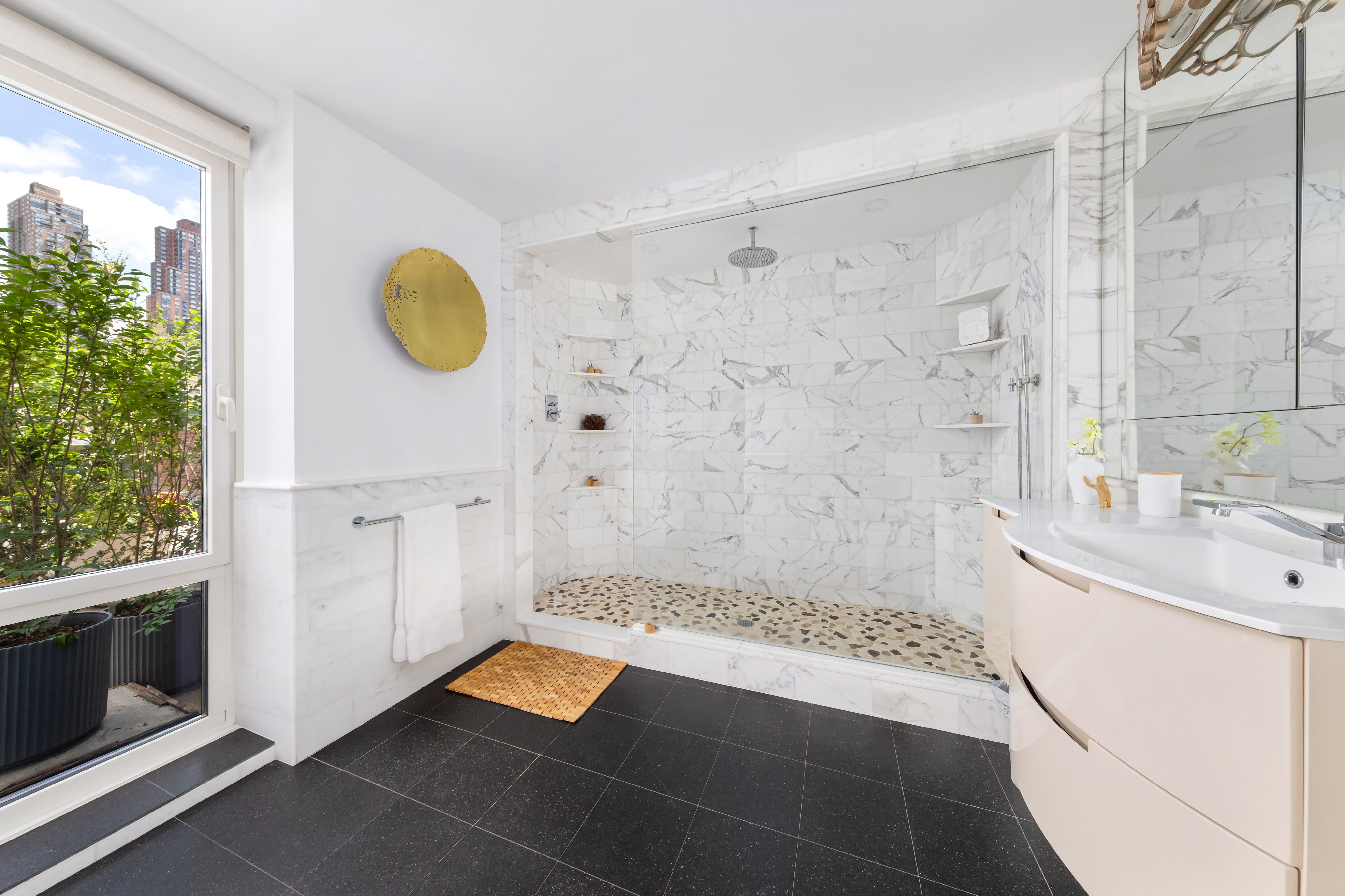454 West 54th Street, Unit 7B Manhattan, NY 10019 - Photo 8 of 15 a bathroom with a tub sink and mirror