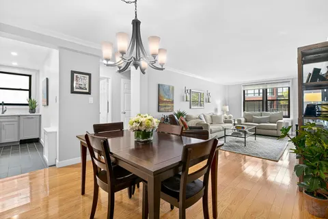 a view of a dining room with furniture and a chandelier