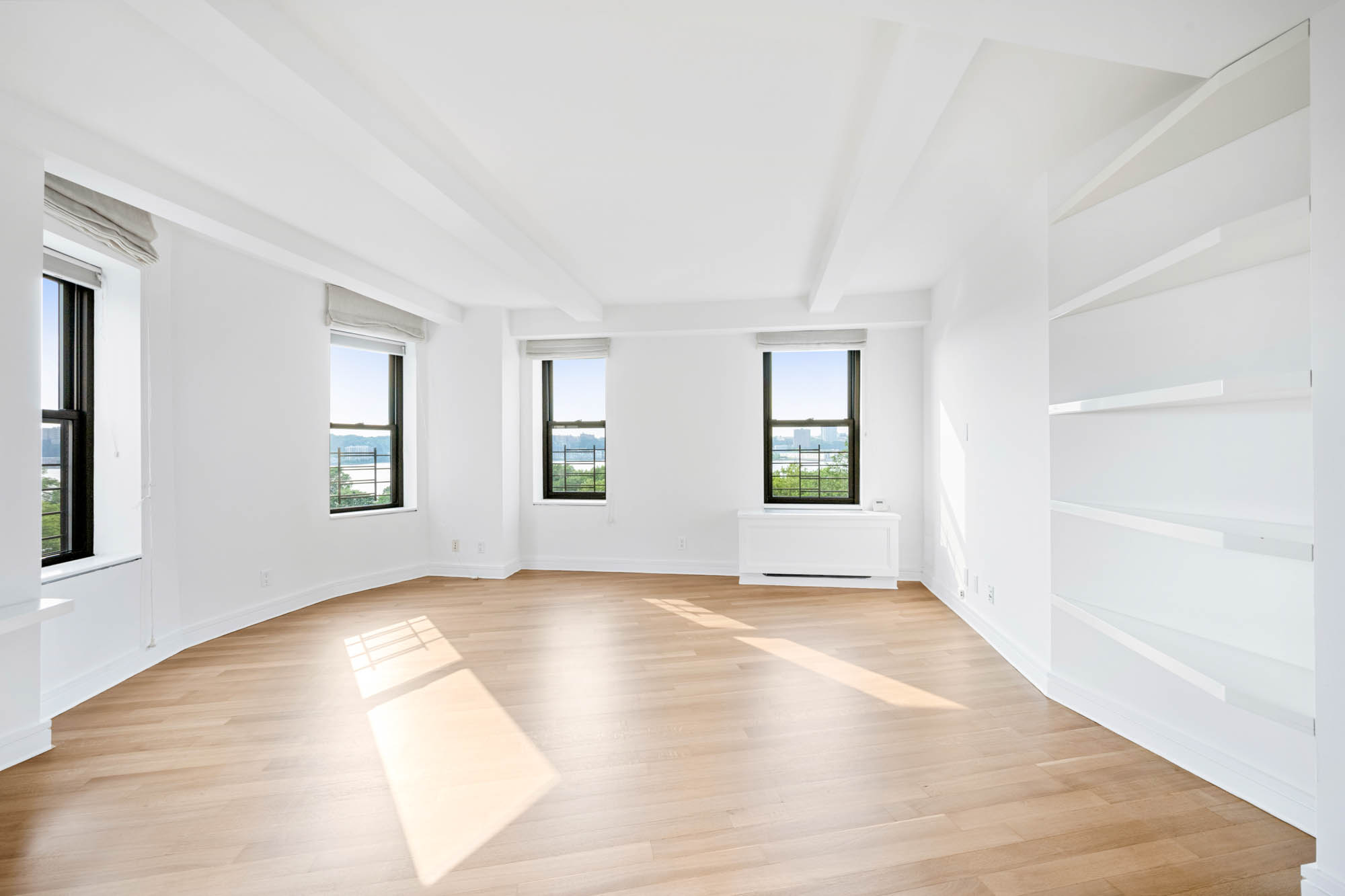 230 Riverside Drive, Unit 8D Manhattan, NY 10025 - Photo 4 of 19 wooden floor in an empty room with a window
