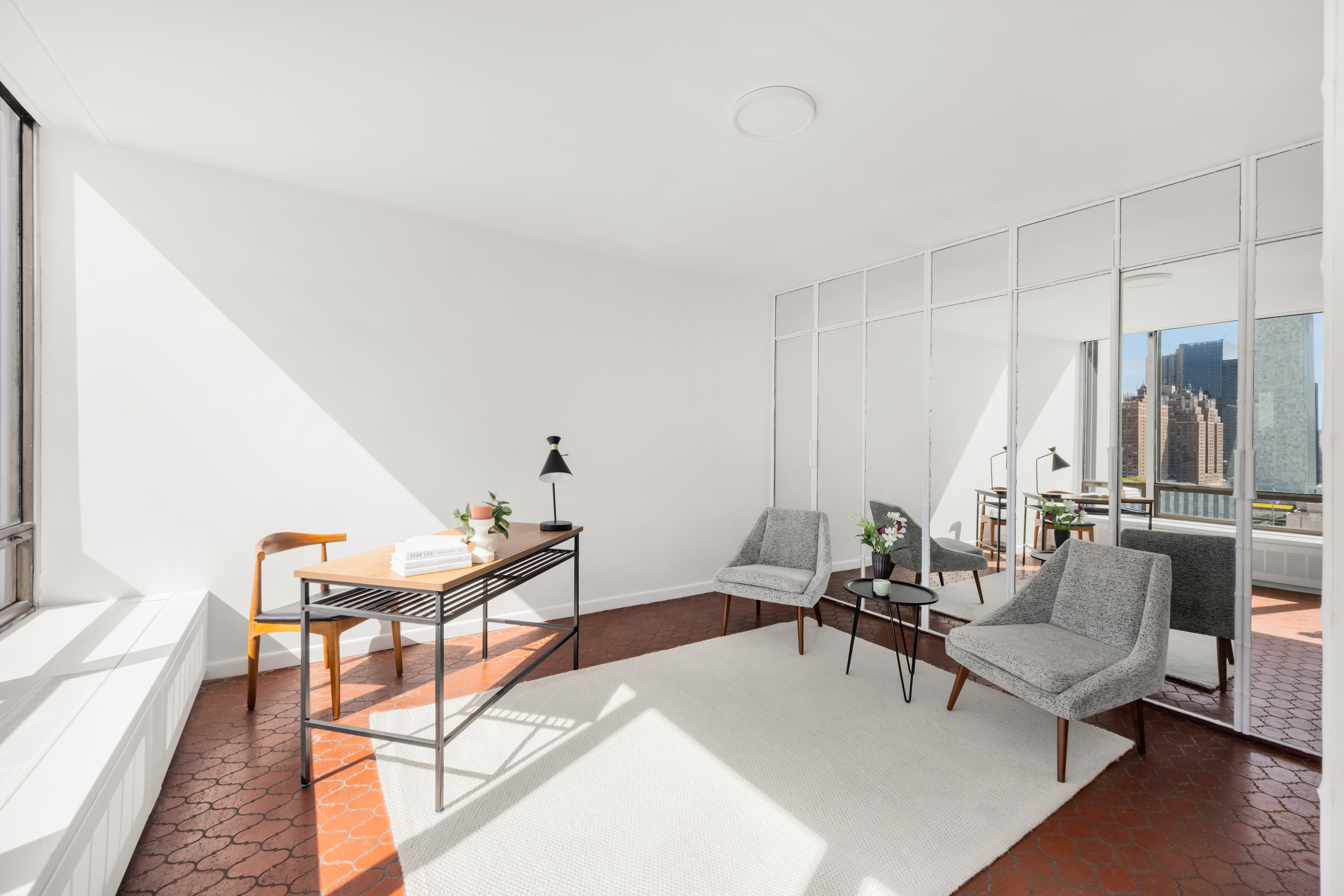 870 United Nations Plaza, Unit 14F Manhattan, NY 10017 - Photo 6 of 16 a living room with furniture and a table