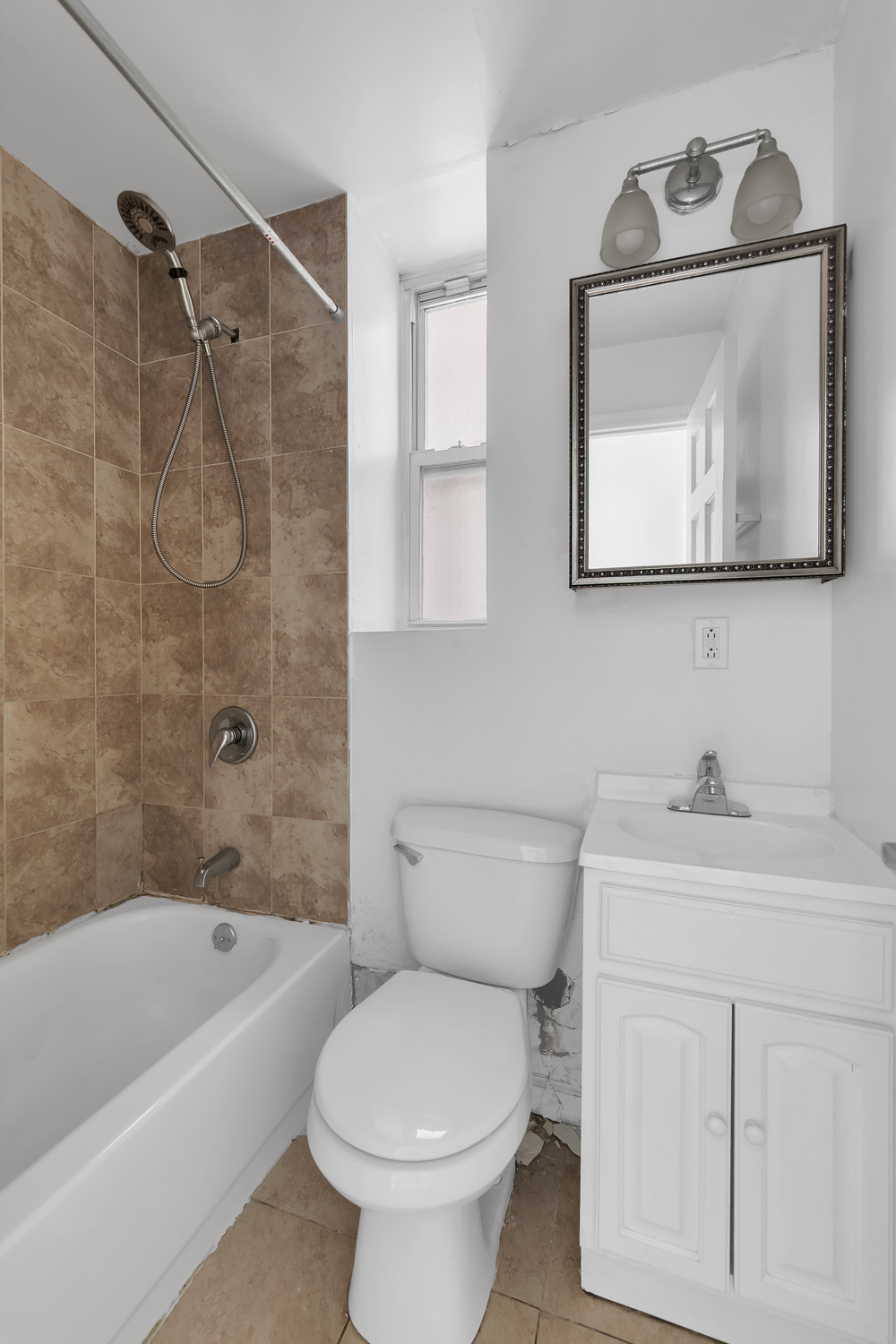 205 West 20th Street, Unit 2W Manhattan, NY 10011 - Photo 3 of 5 a bathroom with a toilet sink and bathtub
