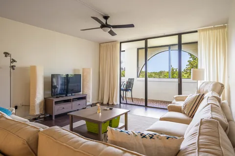 a living room with furniture a flat screen tv and a floor to ceiling window