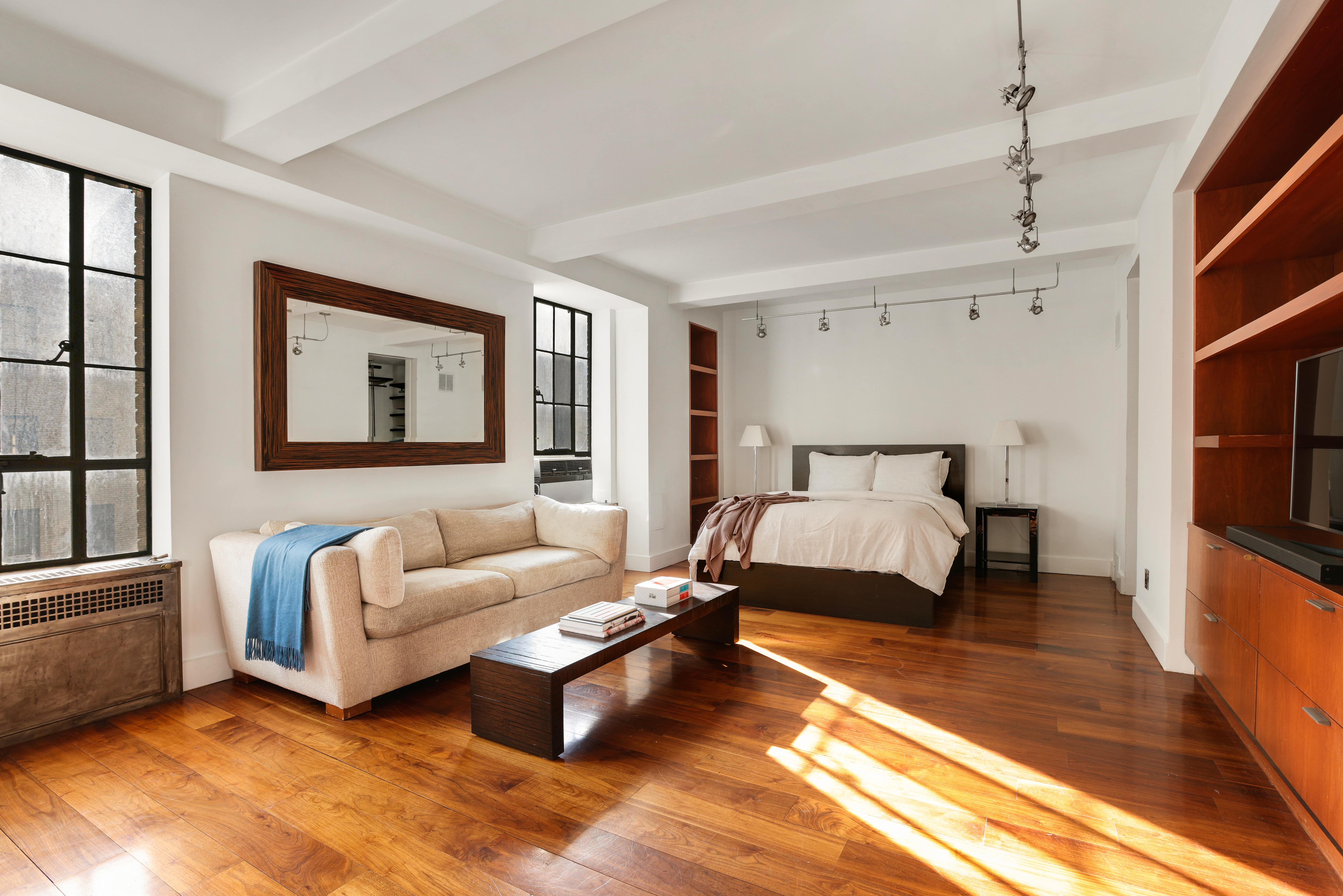 340 West 57th Street, Unit 8E Manhattan, NY 10019 - Photo 4 of 16 a spacious bedroom with a bed couch and a window