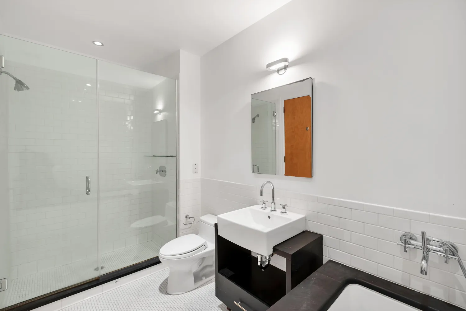 a bathroom with a toilet sink a mirror and shower