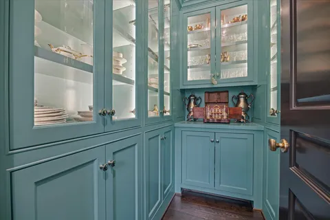 a kitchen with stainless steel appliances white cabinets and a large window