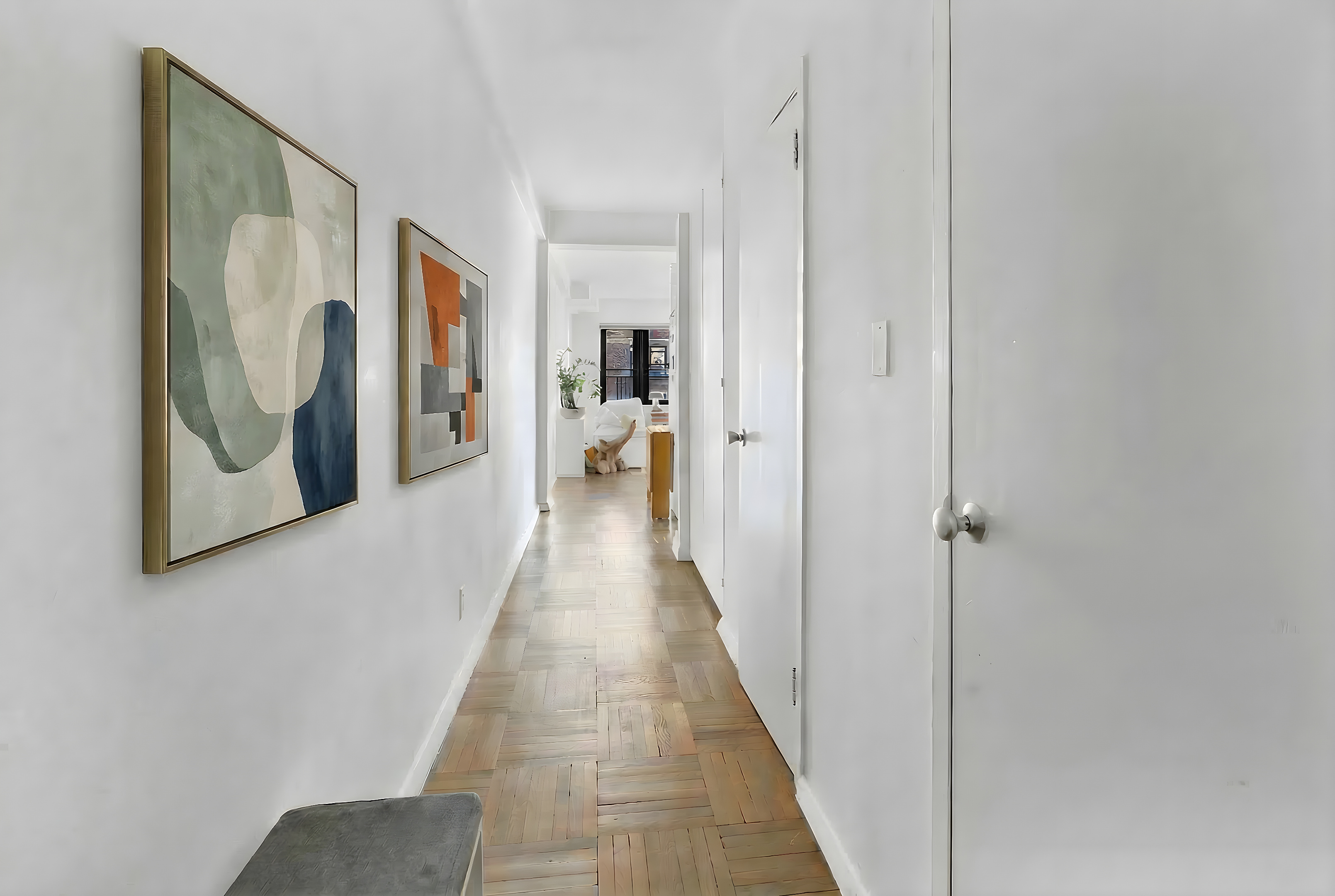 2 Tudor City Place, Unit 15AS Manhattan, NY 10017 - Photo 2 of 17 a hallway with wooden floor and closet