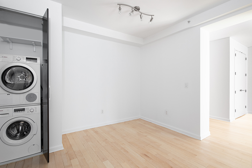 13-11 Jackson Avenue, Unit 9B Queens, NY 11101 - Photo 3 of 11 a view of a storage & utility room with dryer and washer