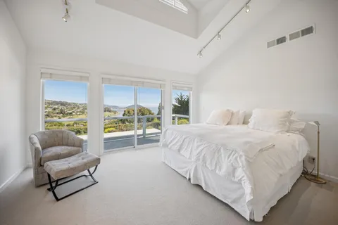 a spacious bedroom with a bed and a couch