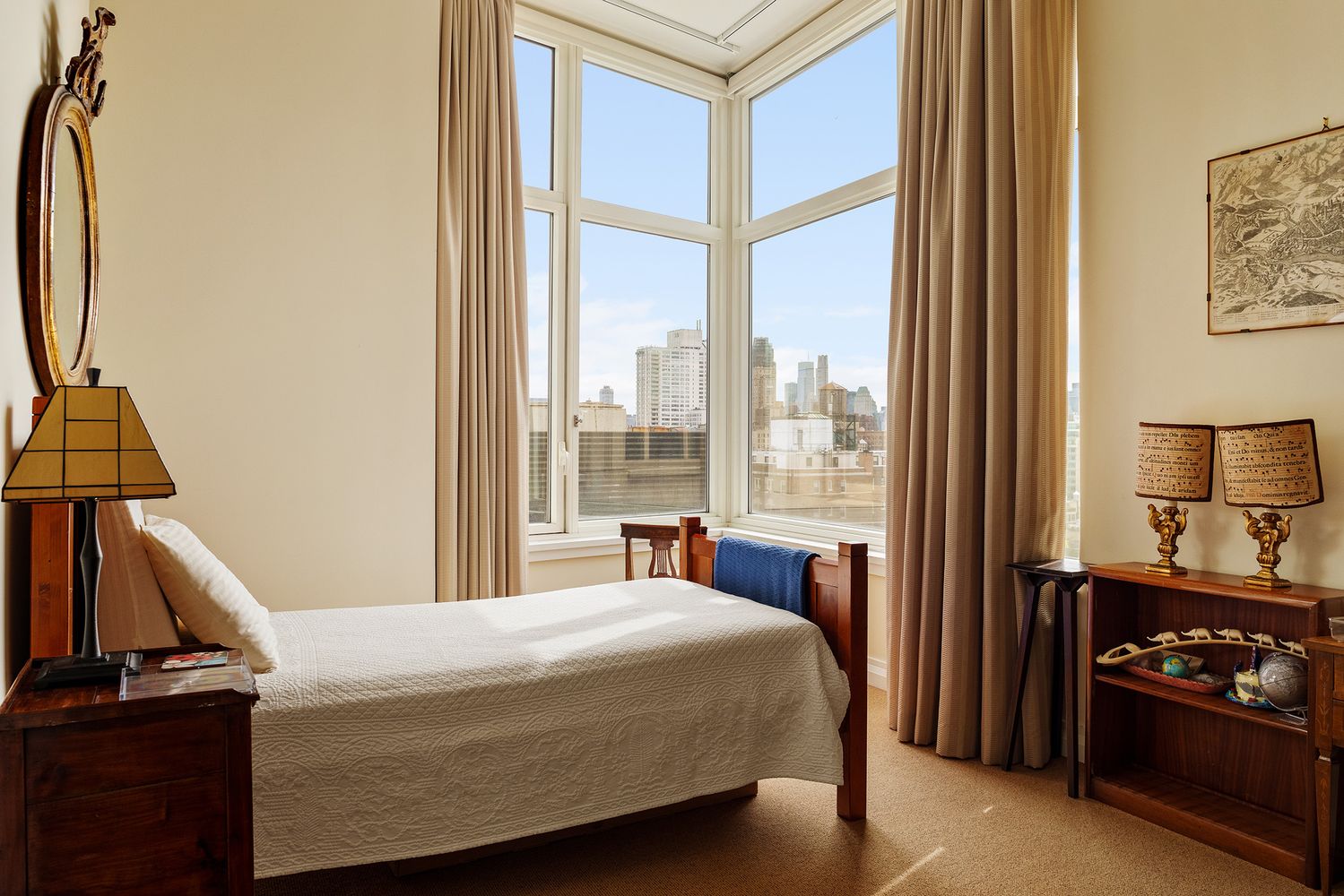 a bedroom with a bed and a flat tv screen on the dresser