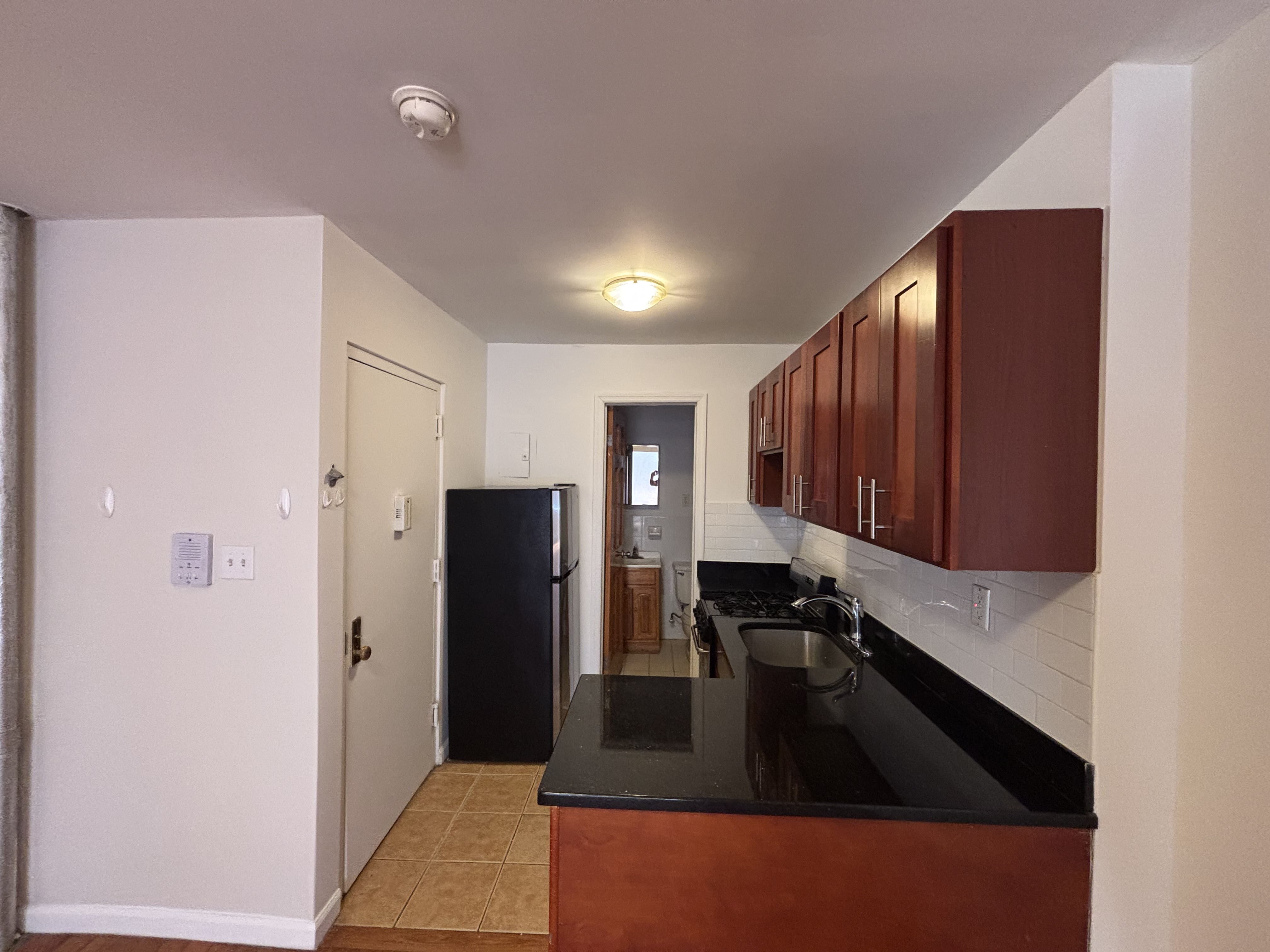 99 St Marks Place, Unit 4B Manhattan, NY 10009 - Photo 6 of 10 a kitchen with a refrigerator and a sink
