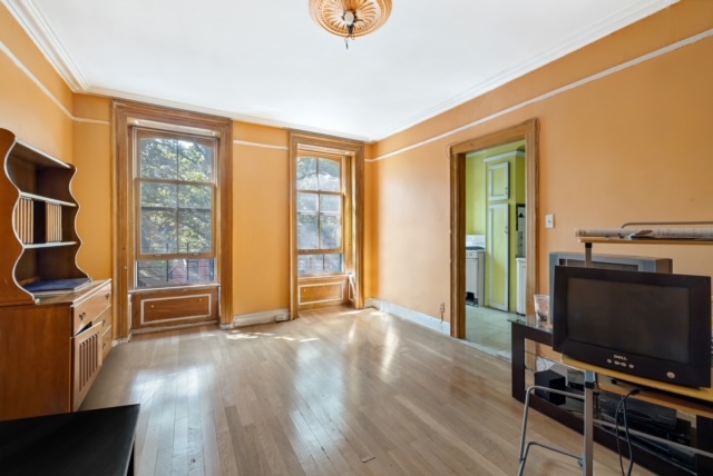 419 Clermont Avenue Brooklyn, NY 11238 - Photo 5 of 14 a view of workspace with furniture and flat screen tv