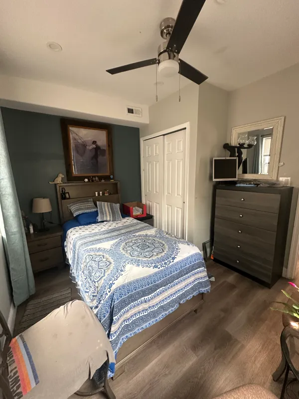 a bedroom with a bed and wooden floor