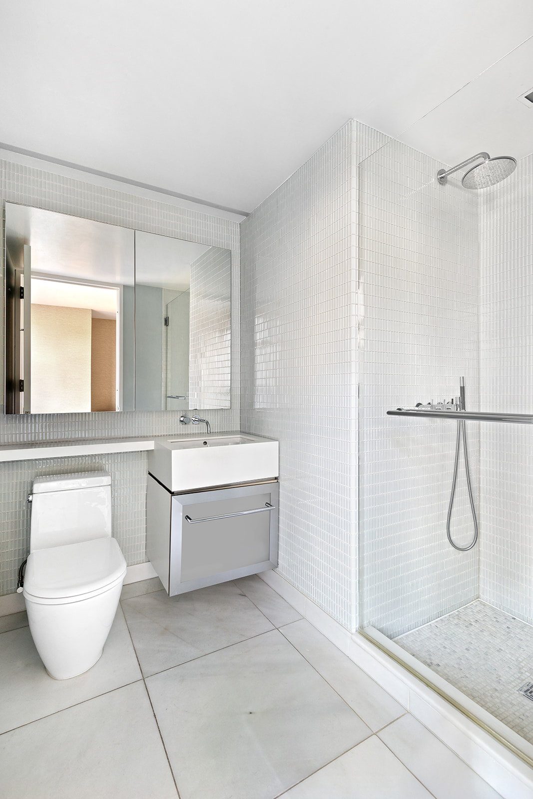 400 East 67th Street, Unit 12D Manhattan, NY 10065 - Photo 7 of 9 a bathroom with a granite countertop sink a toilet and a mirror