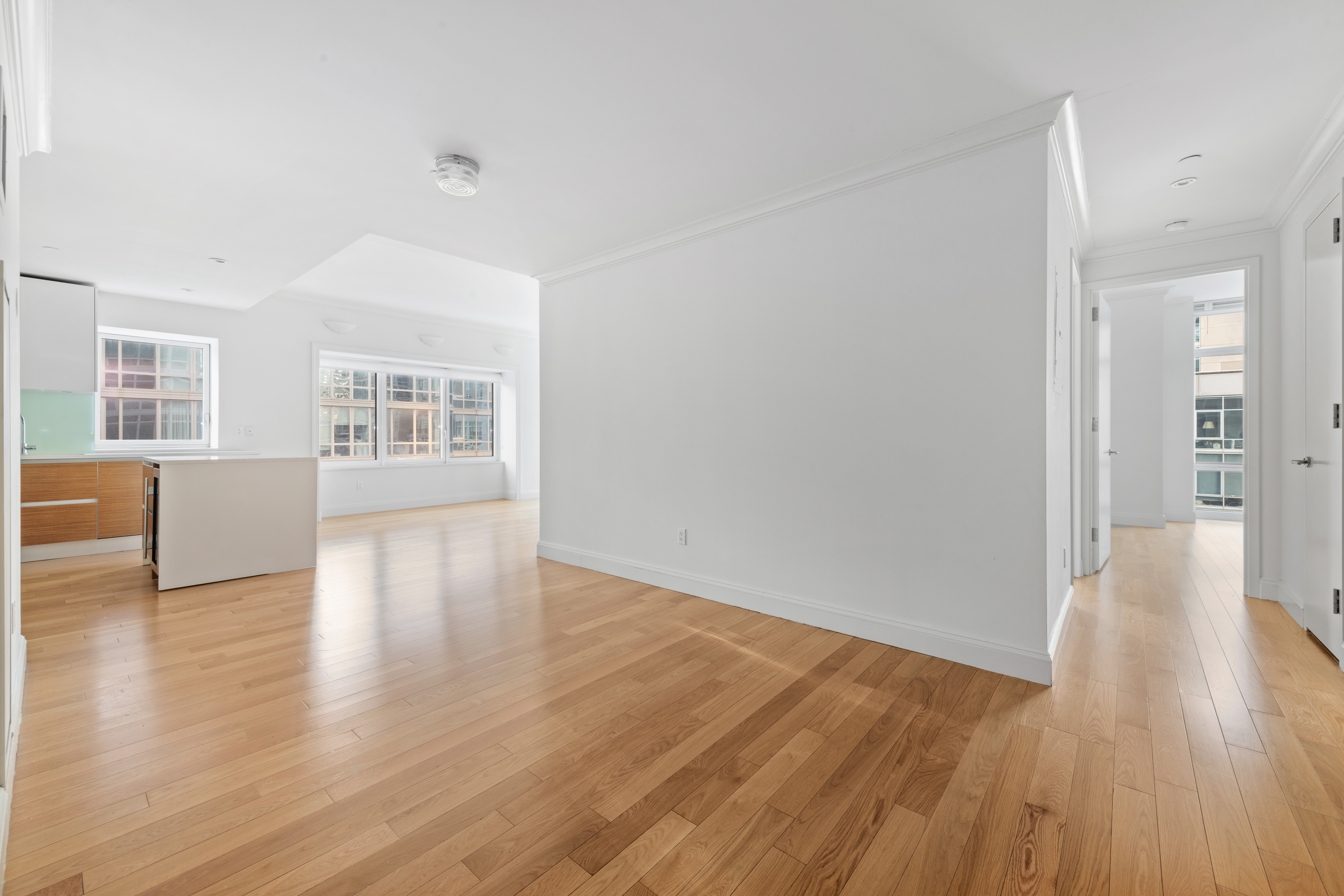 555 West 59th Street, Unit 8B Manhattan, NY 10019 - Photo 4 of 14 a view of a livingroom with wooden floor and windows