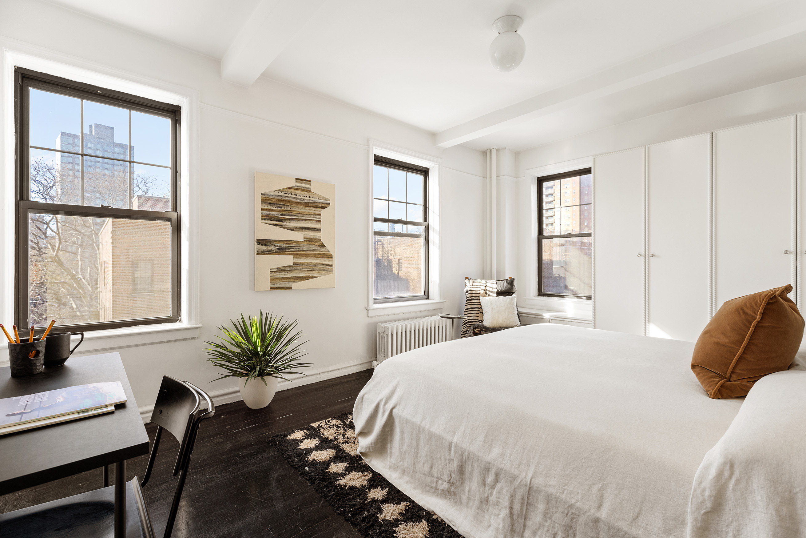 141 East 3rd Street, Unit 5H Manhattan, NY 10009 - Photo 6 of 12 a bedroom with a bed window and table chair