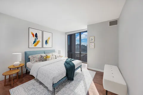 a bedroom with a bed and a painting on the wall