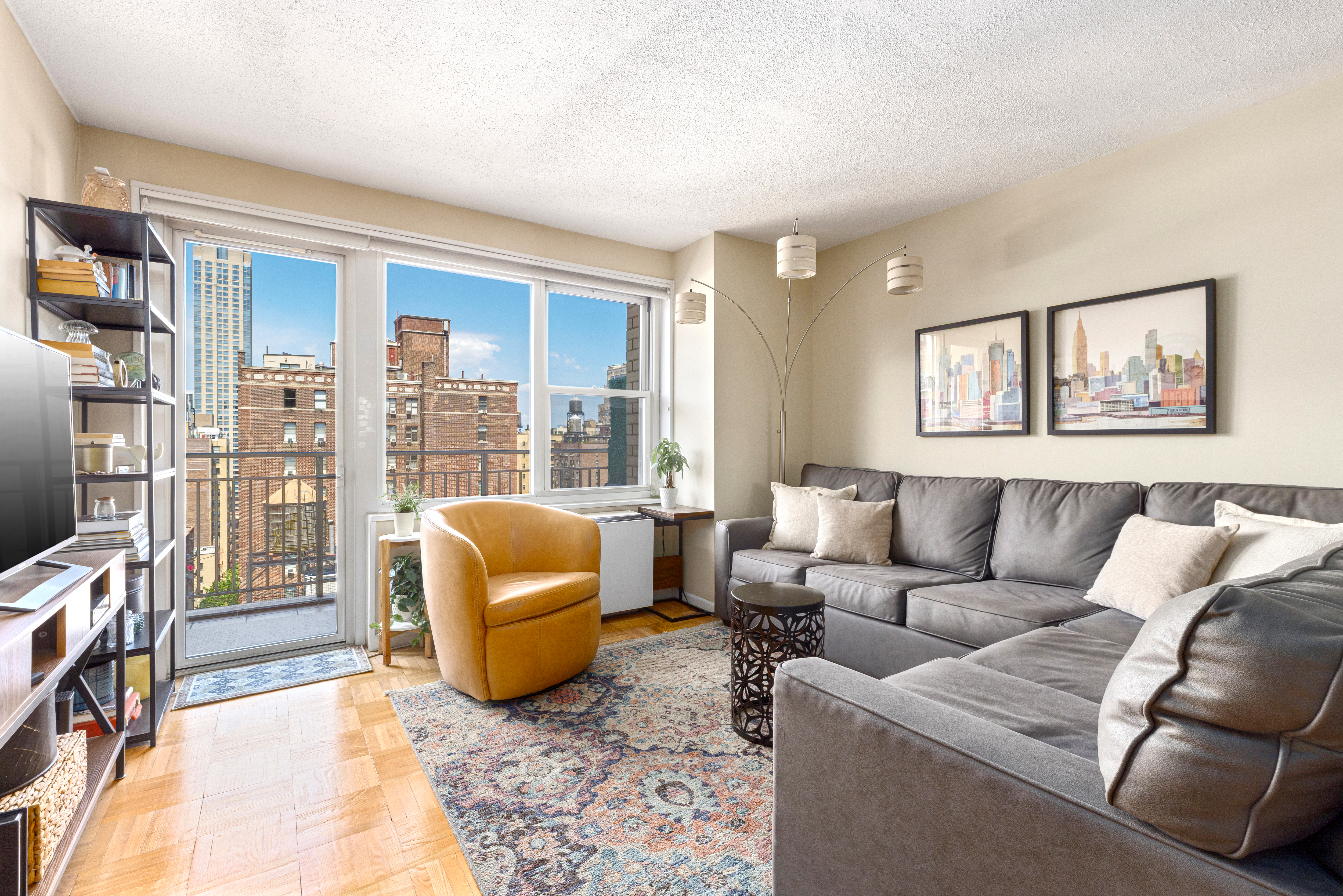 a living room with furniture and a floor to ceiling window
