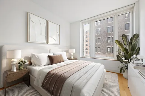 a bedroom with a balcony a bed and a potted plant
